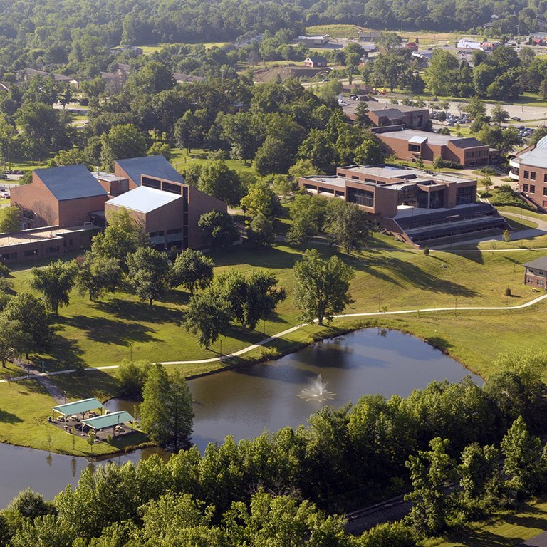 An aerial view of IU Southeast, with buildings, trees, and a pond